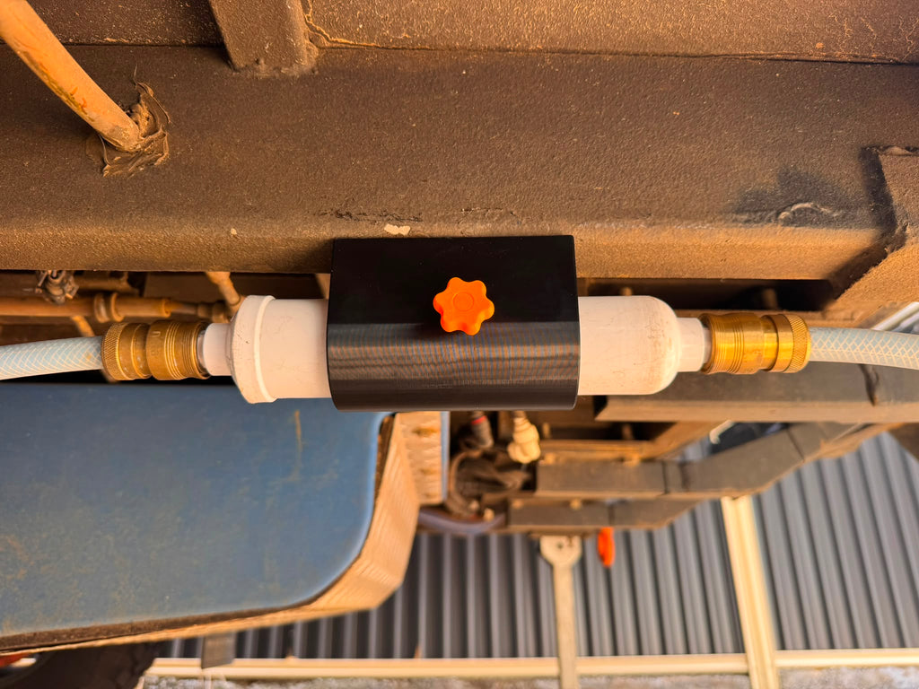Magnetic water filter holder installed on caravan underside